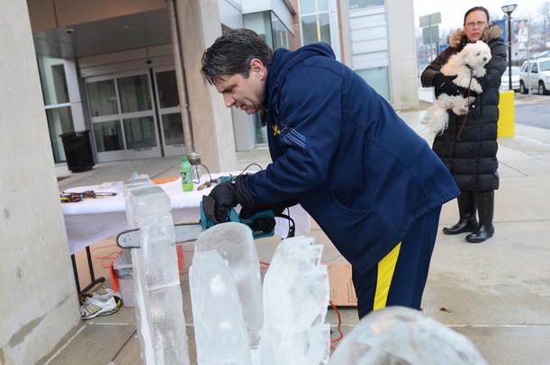 William Collins, of Ann Arbor, carves one of three ice block sculptures outside of the Kellogg Eye Center on Thursday, Feb. 14. Collins etched one of the carvings with the message "Will U Marry Me?" and planned to surprise his girlfriend Beth Ryan with a proposal. Melanie Maxwell I AnnArbor.com